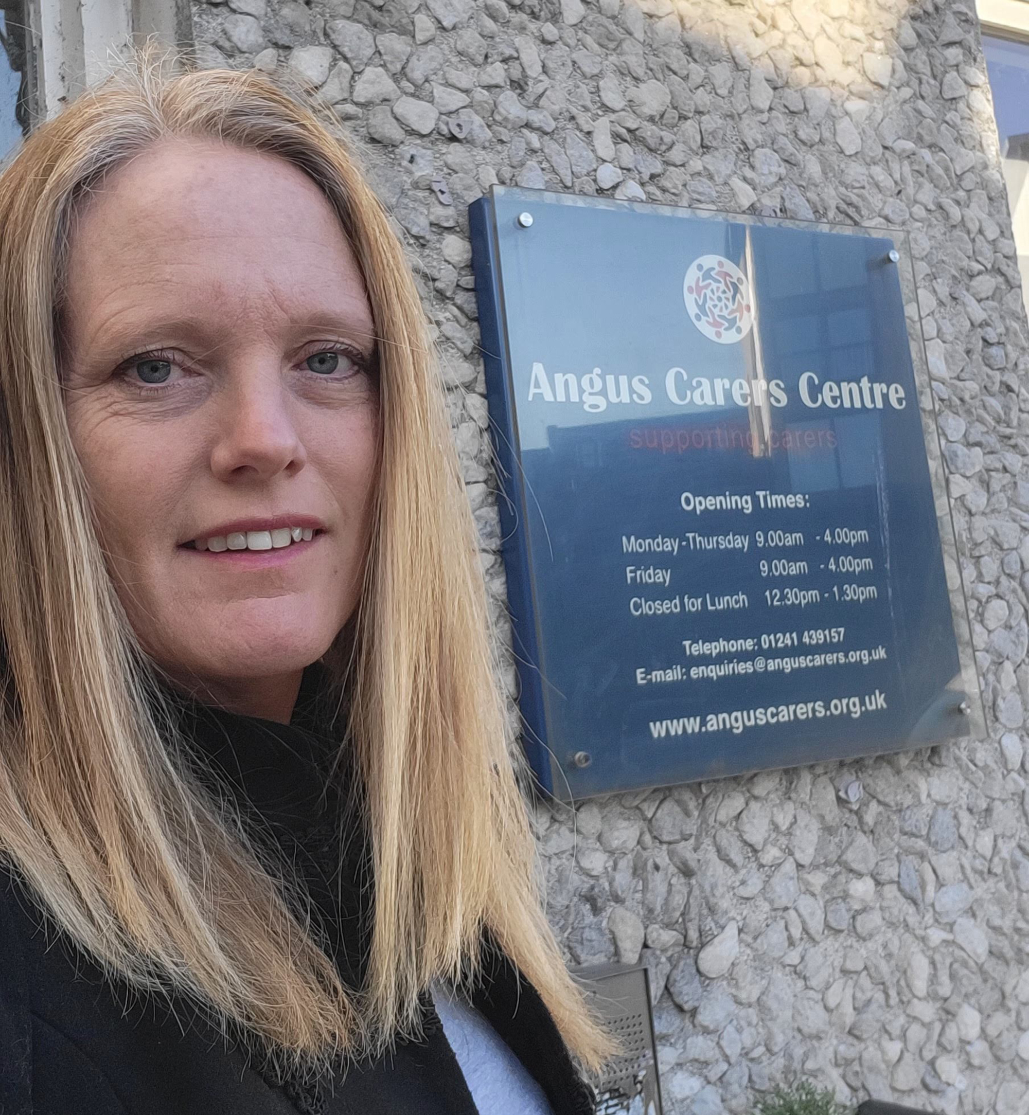 D&A member of staff Mel standing in front of Angus Carers Centre)