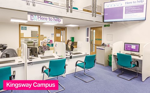 Photo of Kingsway campus Help Point with two members of staff working at desk
