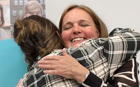 People hugging at awards event