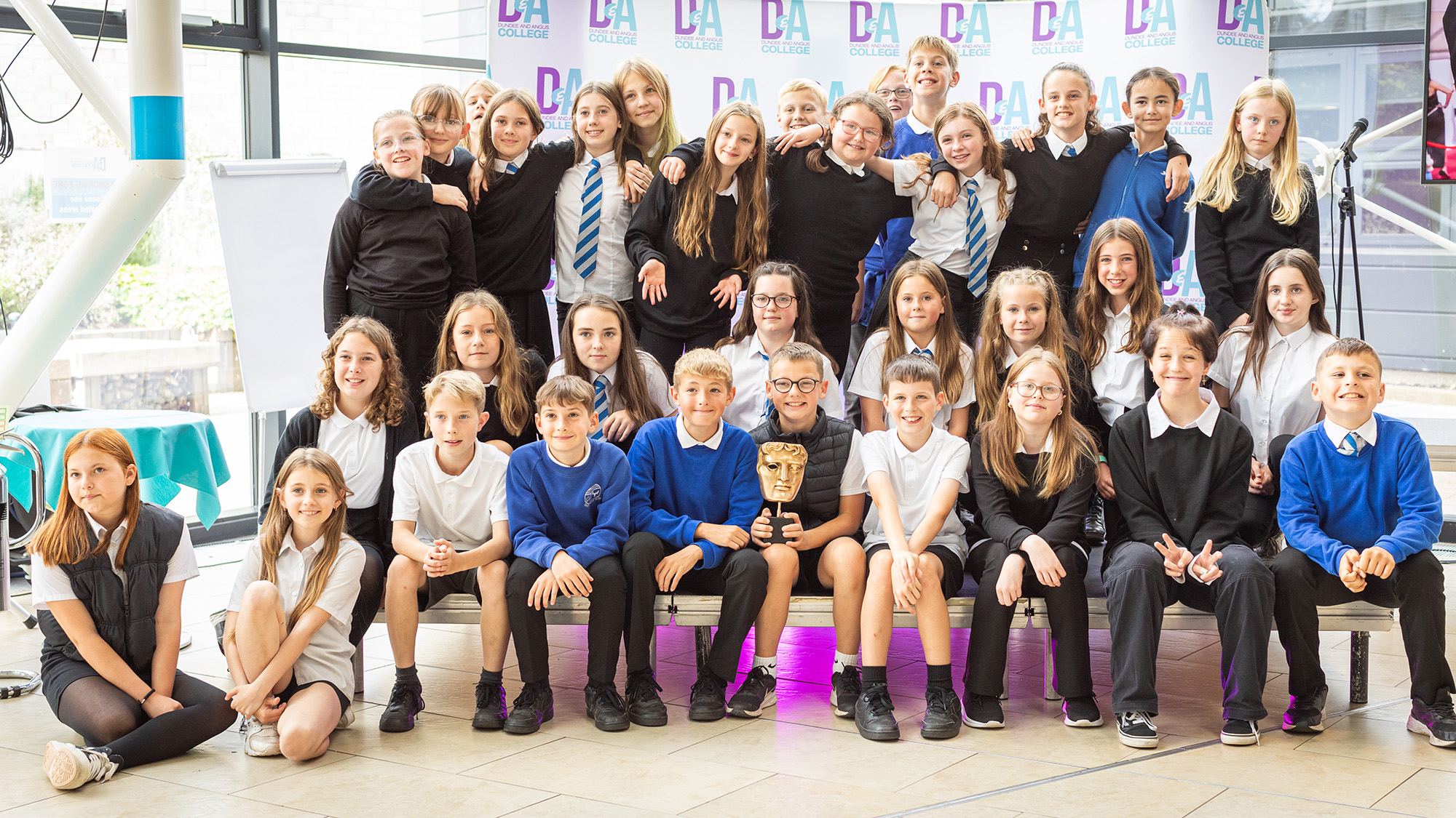 Photo of class of school pupils posting with BAFTA trophy)