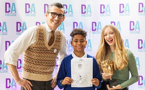 BAFTA hosts posing for photo with a school pupil holding a drawing