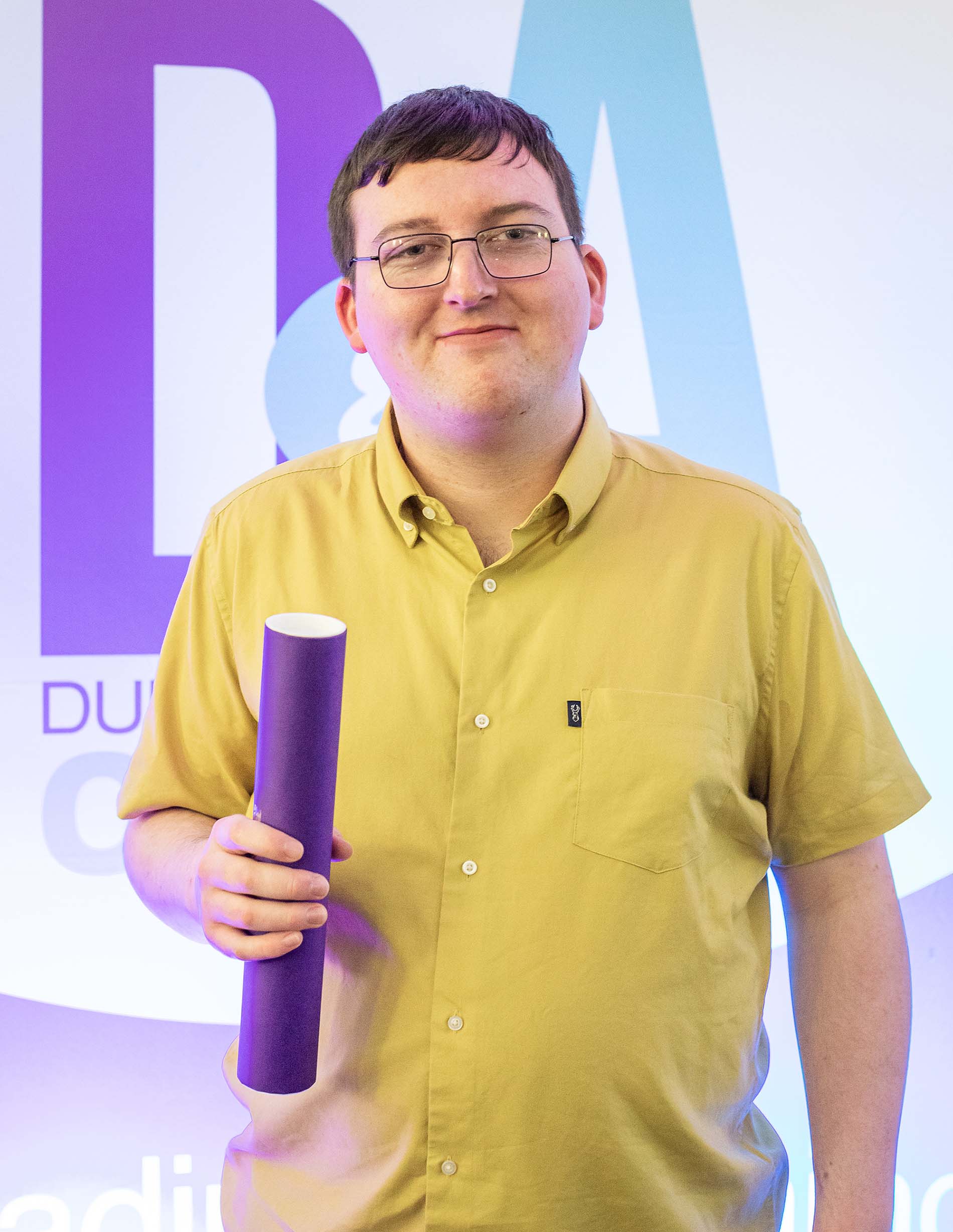 Student holding D&A certificate tube