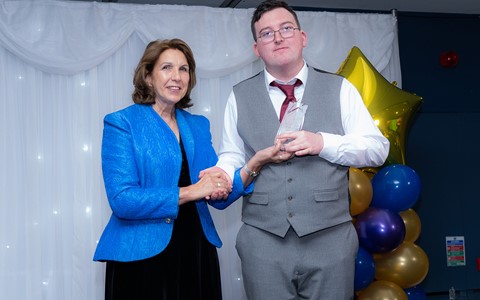 Student being presented with trophy at NHS Star Awards