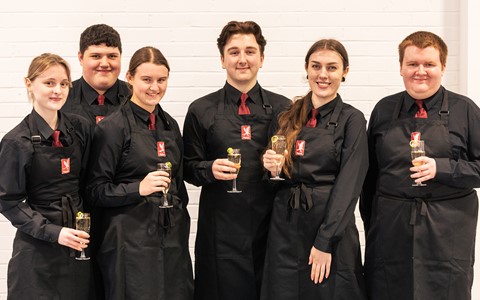 Group of hospitality students holding drinks