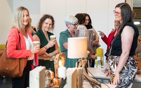 People enjoying coffee, chatting and looking at the crafts for sale