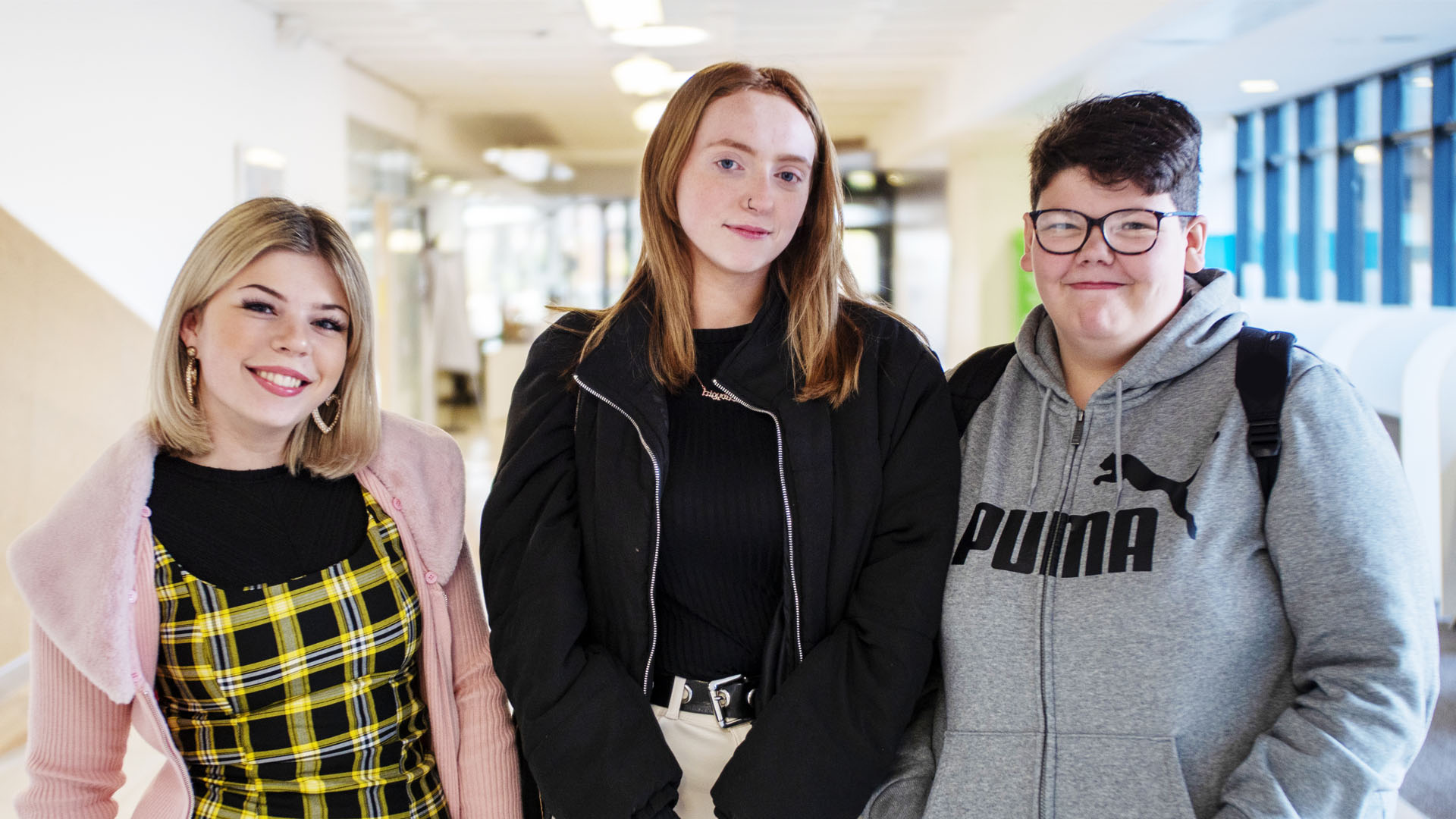 Three students standing smiling at our Gardyne Campus)