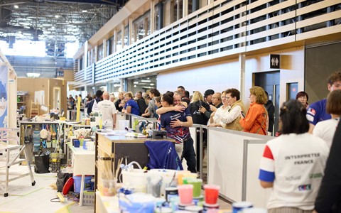 Celebrating the end of the WorldSkills competition, photo has painting and decorating items with audience looking on