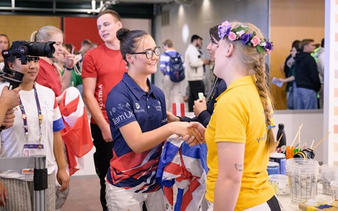 Dior shaking hands with another competitor at the WorldSkills competition
