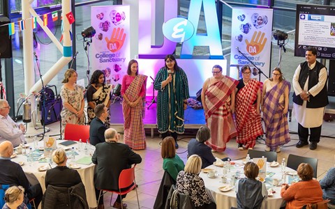 Photograph of the Mobile Teaching Kitchen giving a talk at the College of Sanctuary event at Gardyne Campus