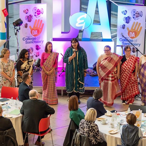 Photograph of the Mobile Teaching Kitchen giving a talk at the College of Sanctuary event at Gardyne Campus