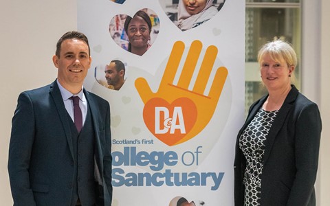 Simon Hewitt, Dundee and Angus College Principal and Shona Robison, Cabinet Secretary for Finance and Local Government standing beside a pop up banner for College of Sanctuary