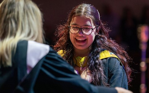 2024 graduation - student crossing stage
