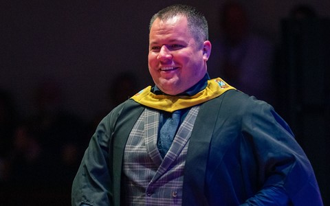 2024 graduation - student crossing the stage