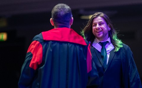 2024 graduation - student crossing the stage