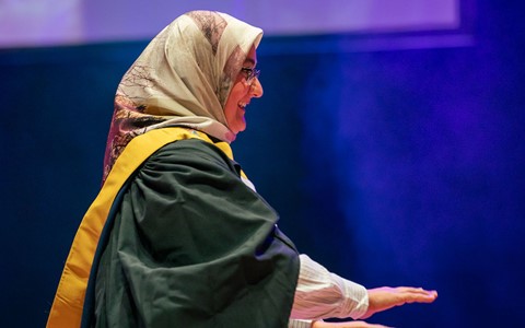 2024 graduation - student crossing the stage