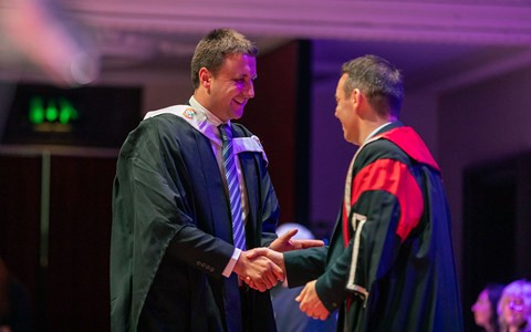 2024 graduation - student crossing the stage