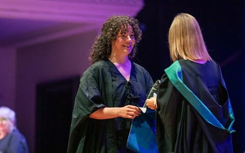 2024 graduation - student crossing the stage