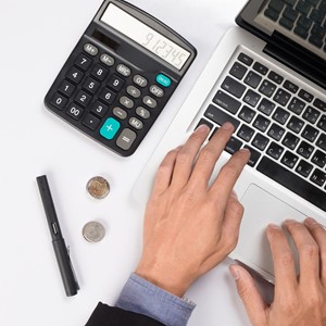 hands with laptop, calculator and coins