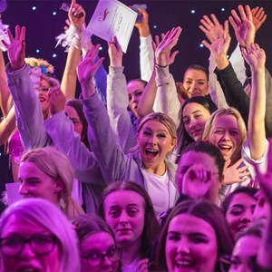 crowd cheering and celebrating a competition win