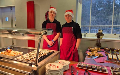 Students ready for the Festive Fayre at our Arbroath Campus surrounded by cakes and mince pies