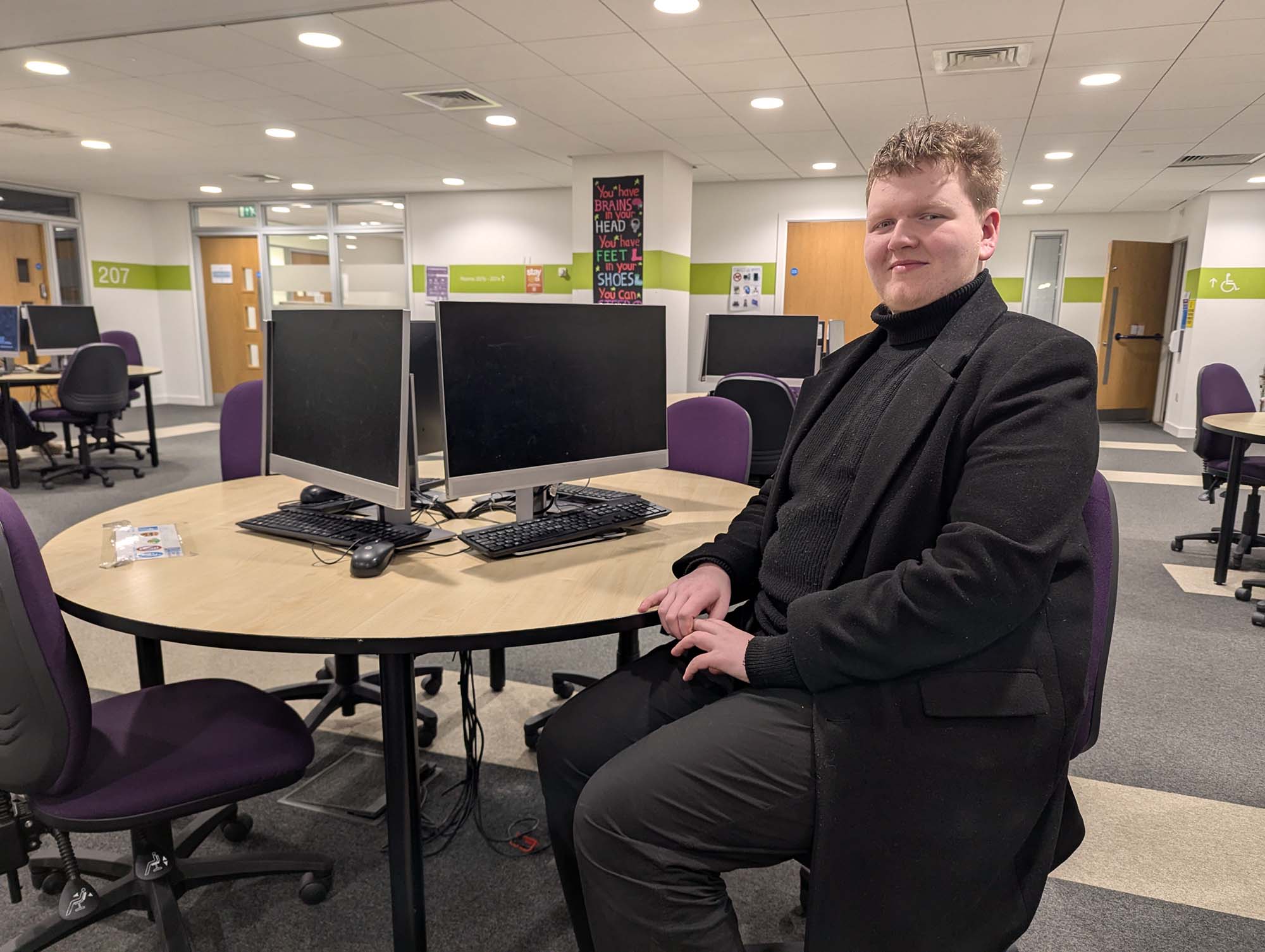 Student Lewis sitting at desk