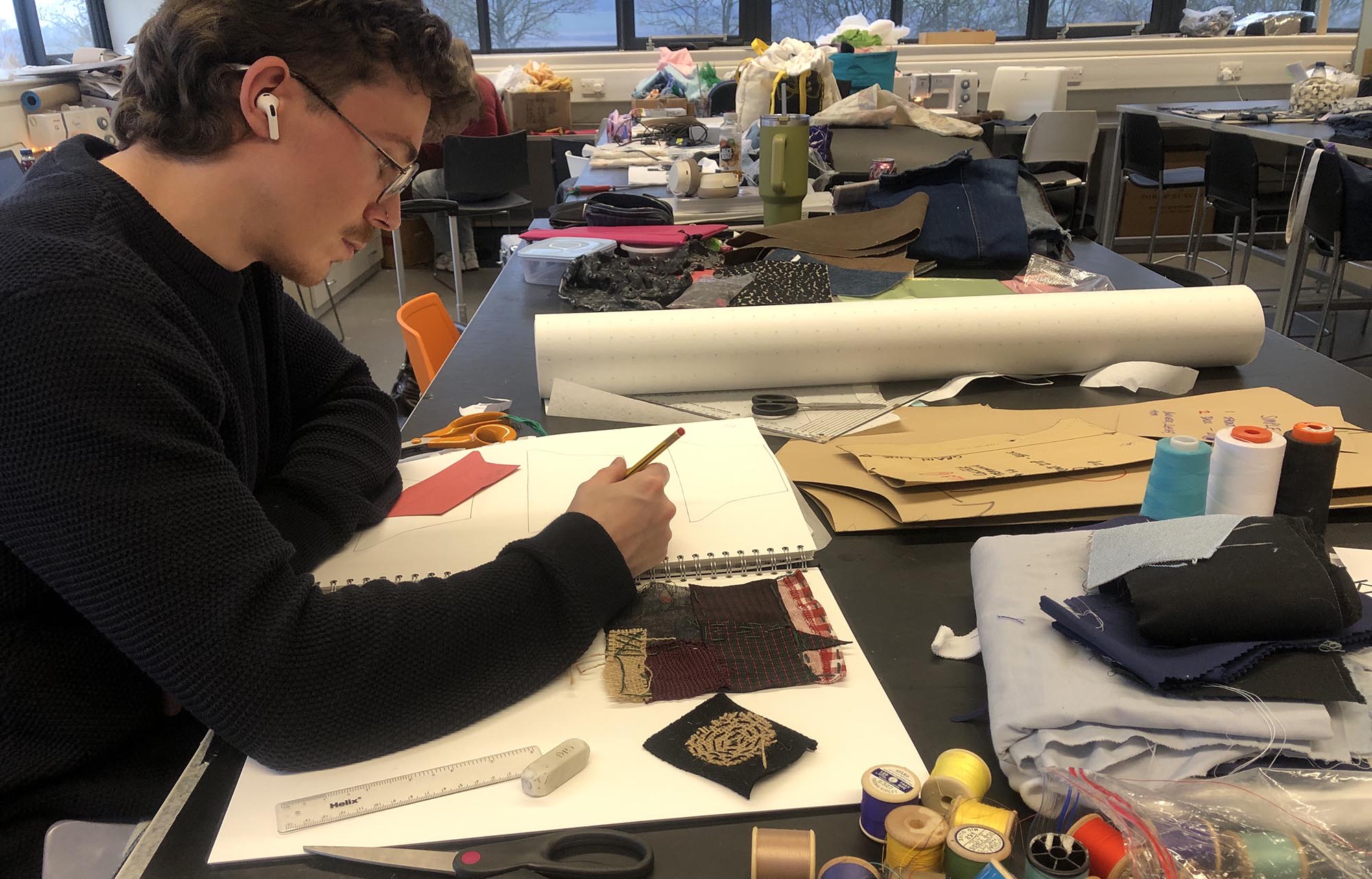 Textiles student with work book