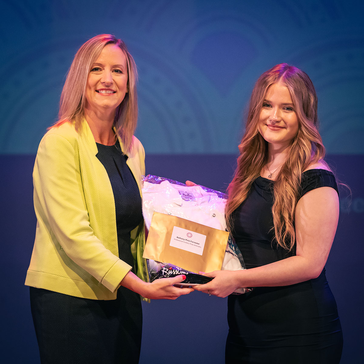 prize winner receiving their prize on stage