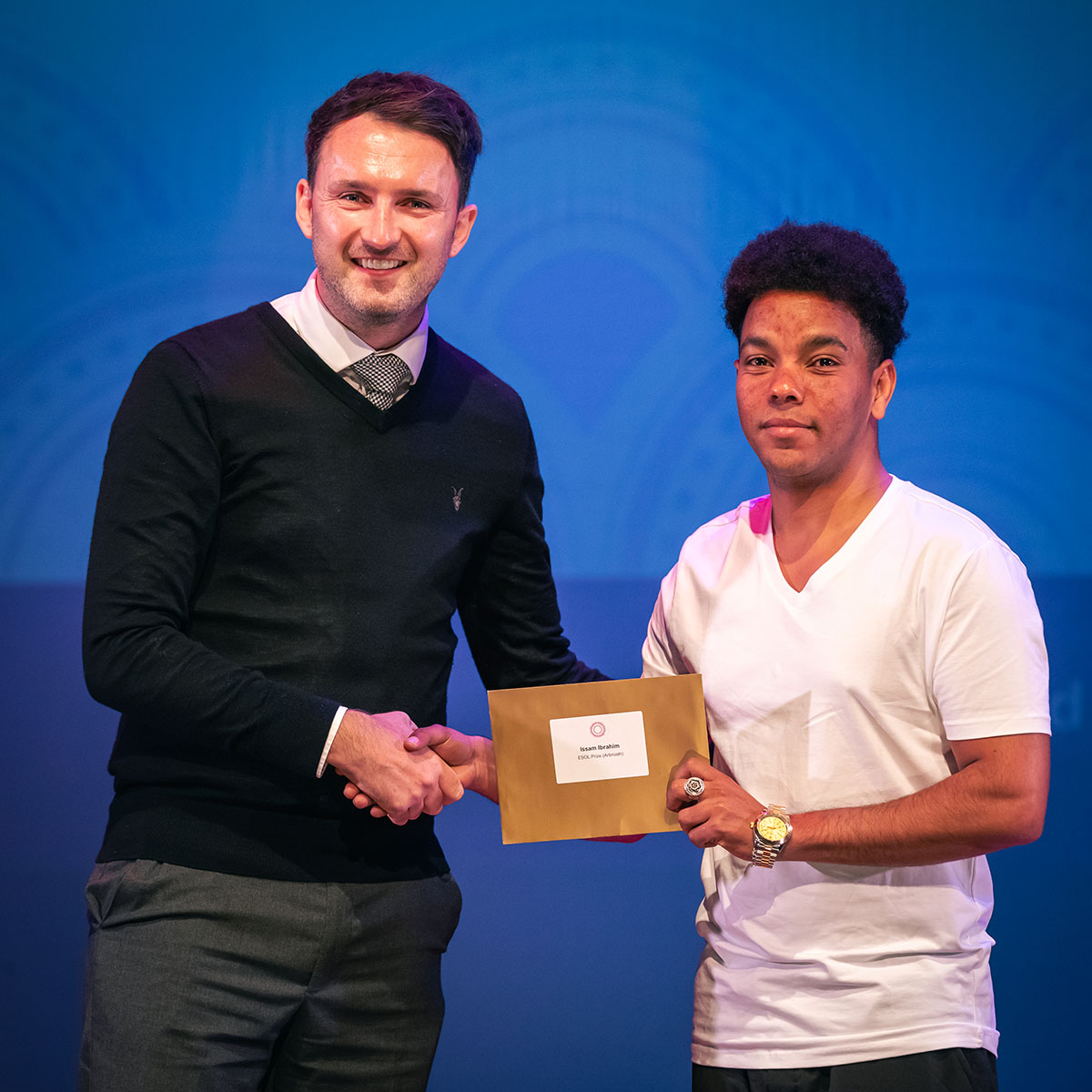 prize winner receiving their prize on stage