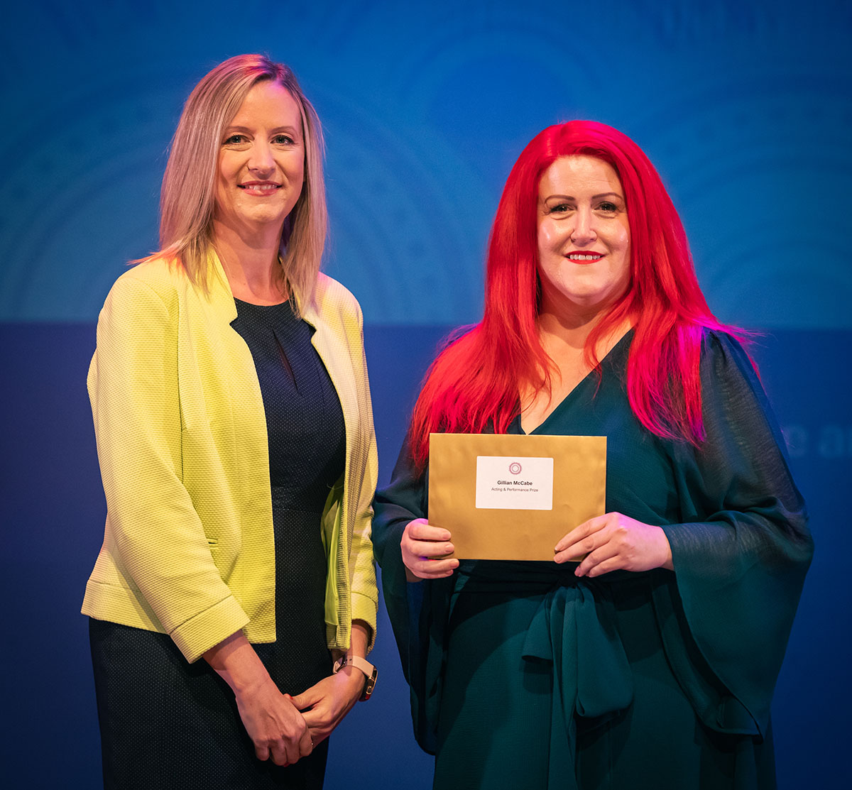 prize winner receiving their prize on stage