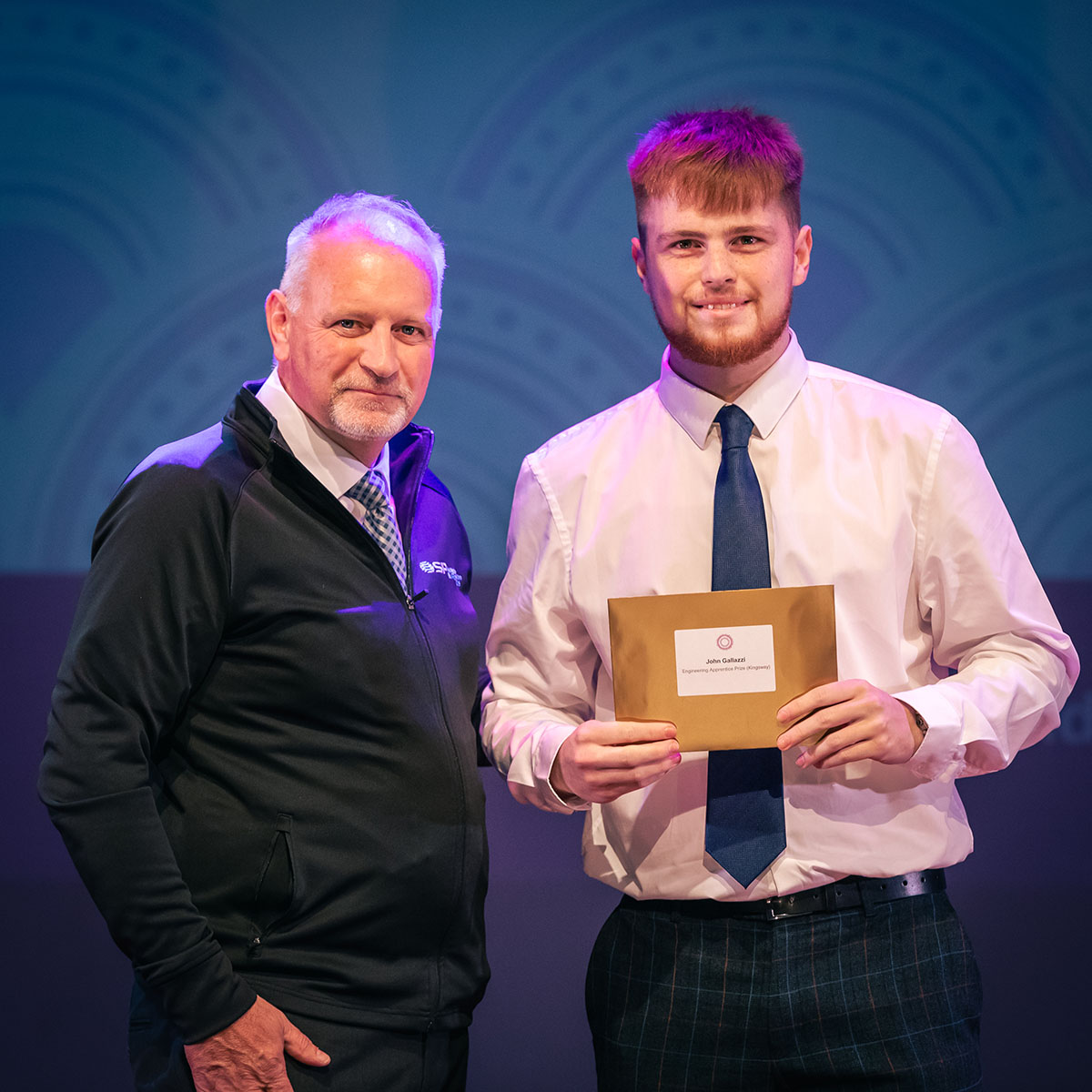 prize winner receiving their prize on stage