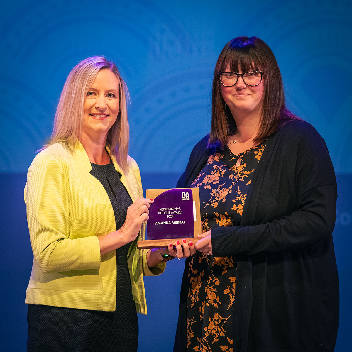 prize winner receiving their prize on stage