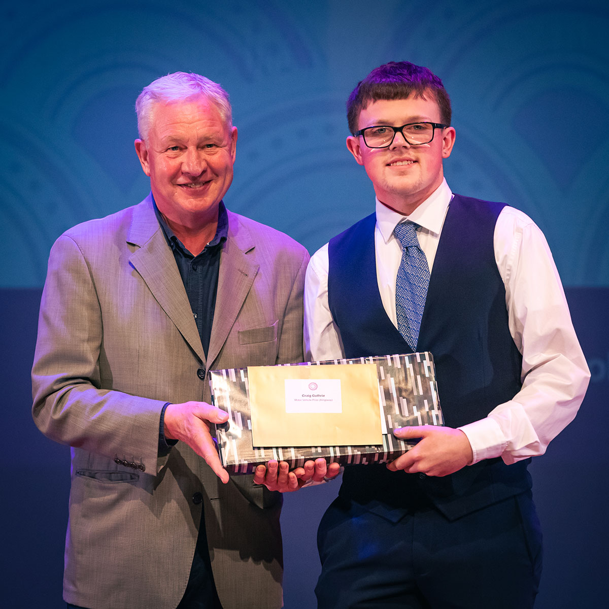 prize winner receiving their prize on stage