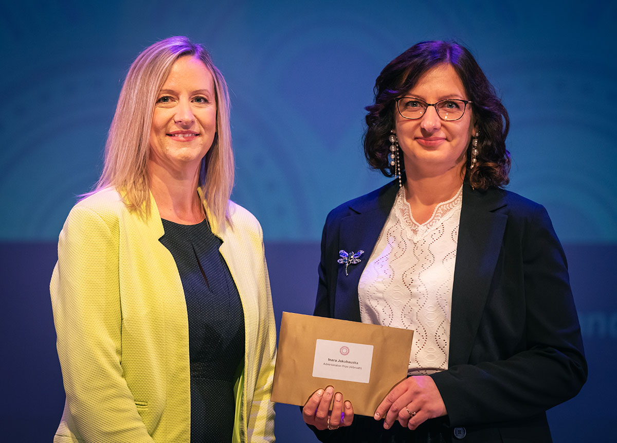 prize winner receiving their prize on stage