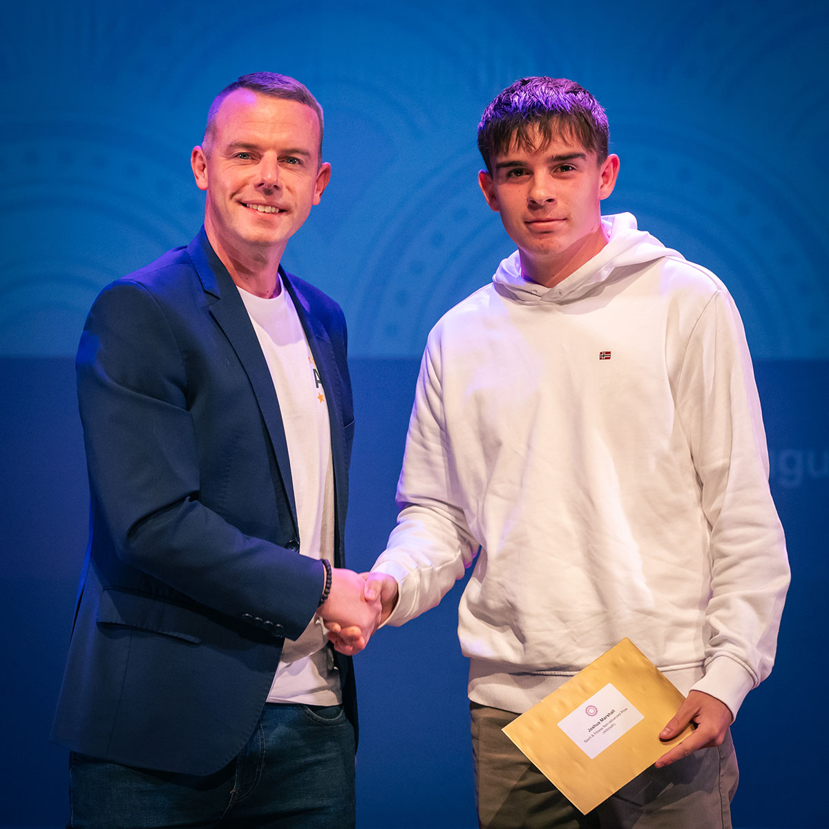 prize winner receiving their prize on stage