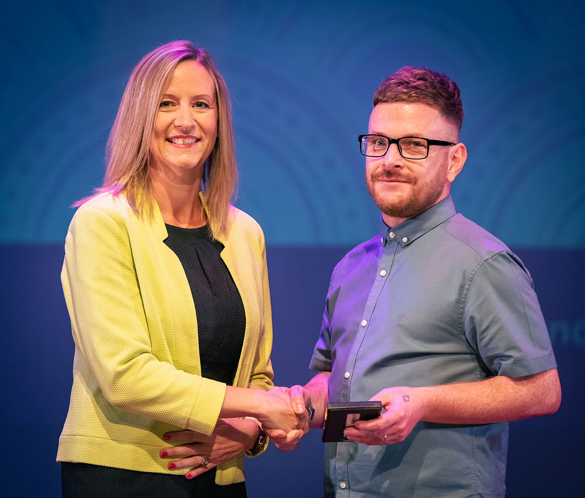 prize winner receiving their prize on stage