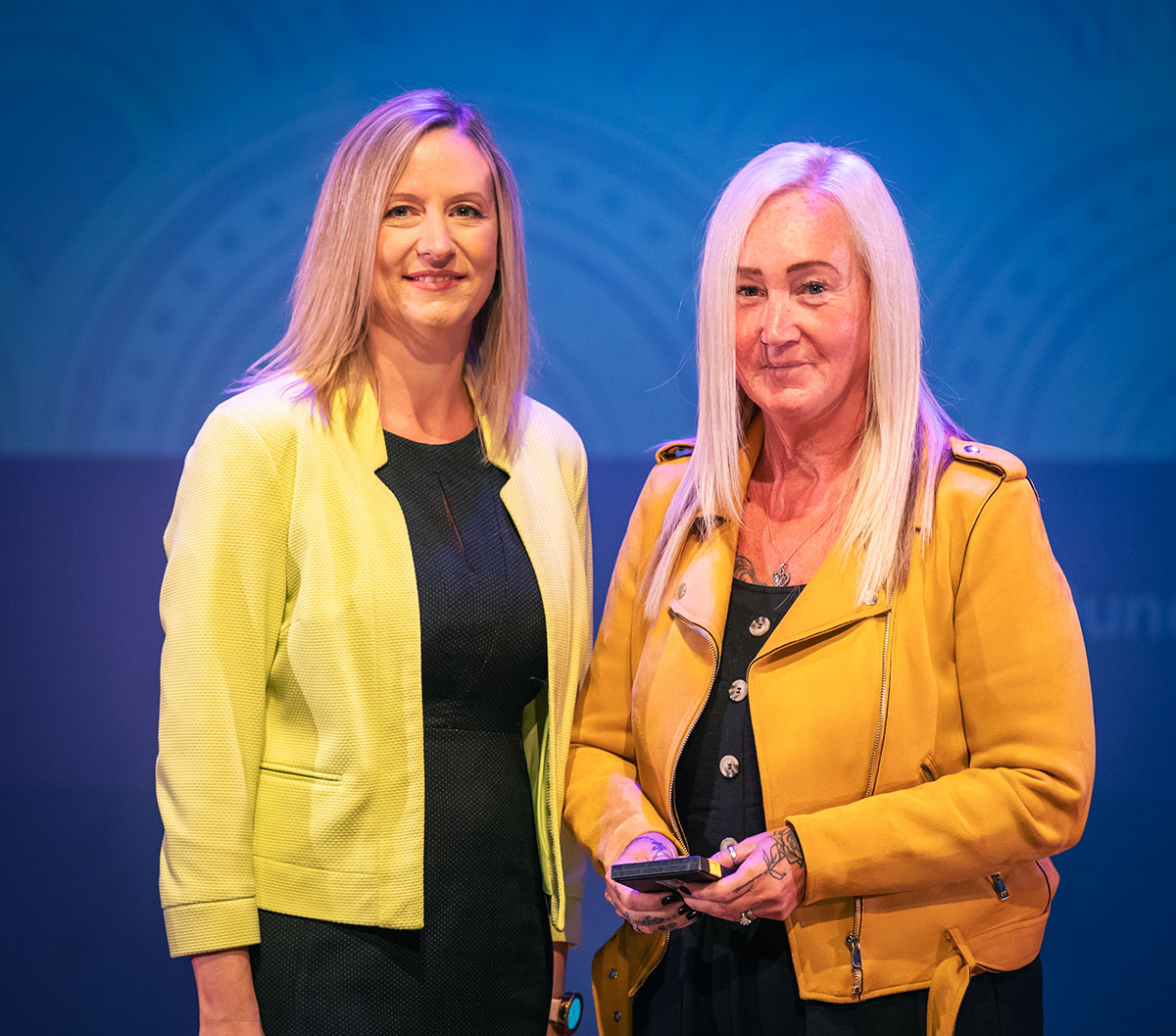 prize winner receiving their prize on stage