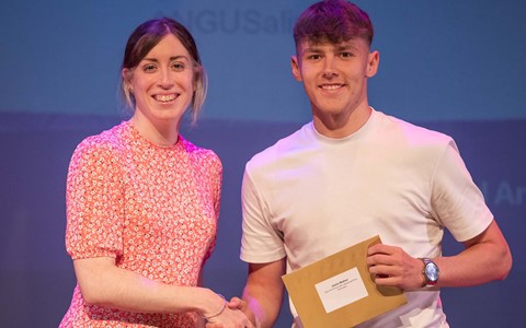 Student receiving prize from woman