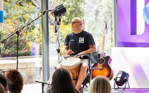 african drummer playing on stage