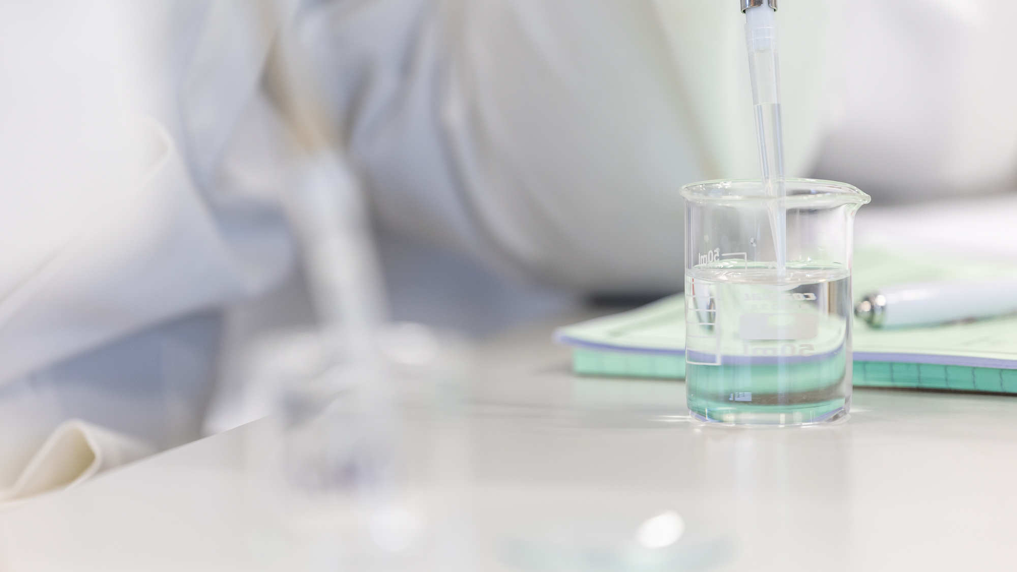 A beaker full of clear liquid in a lab
