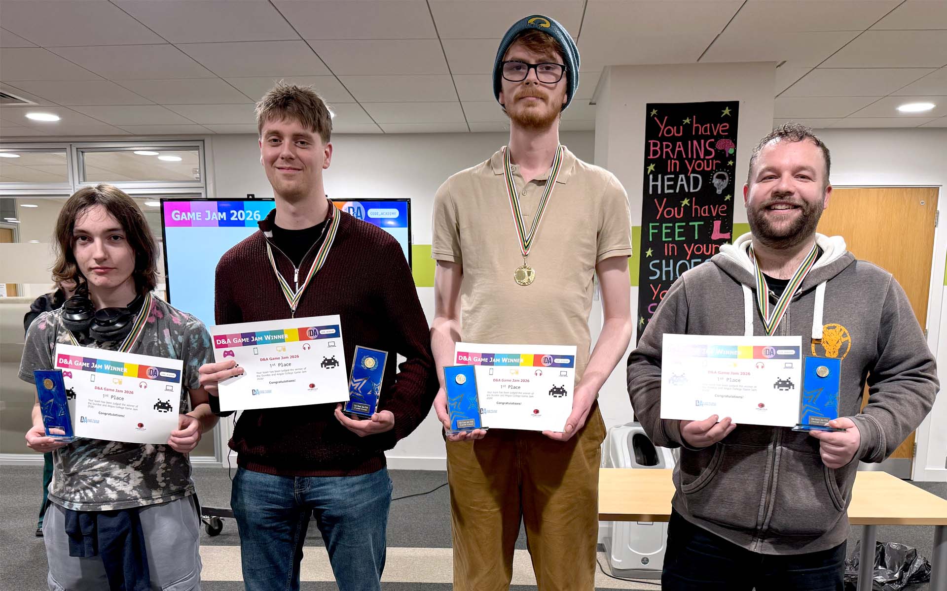 Team of students holding certificates and trophy