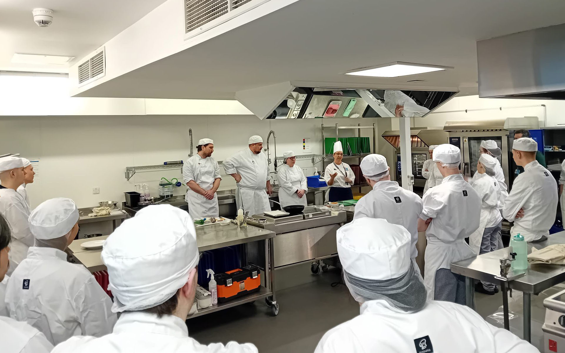 Professional Cookery lecturer speaking in front of class of students