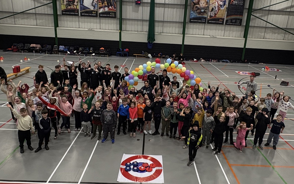 Group photo of people celebrating at school curling event