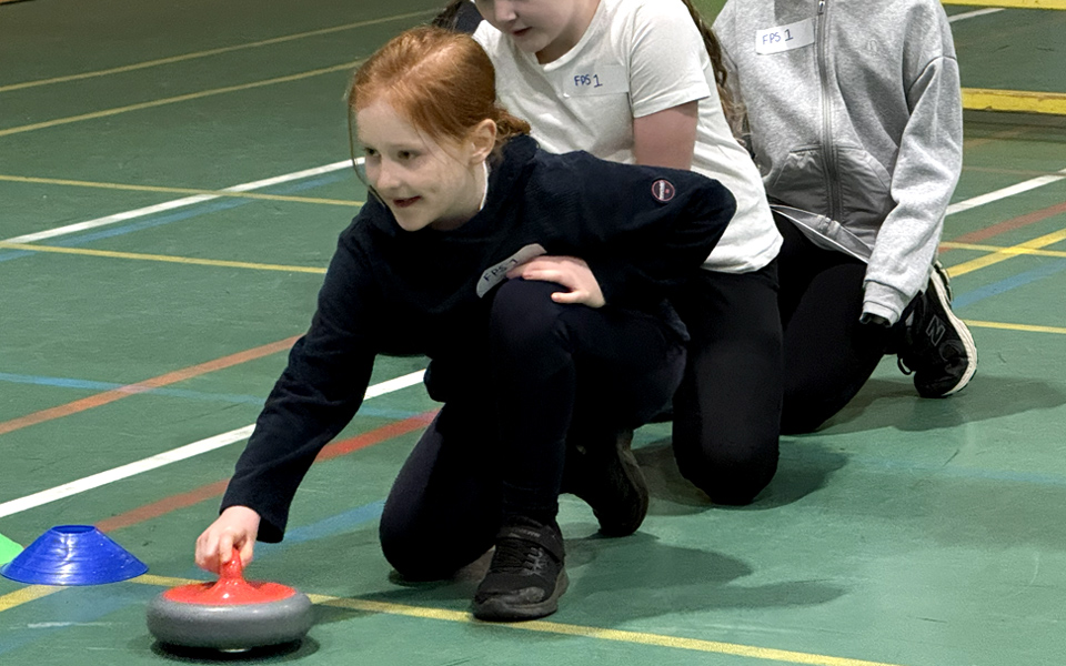 School pupil playing curling