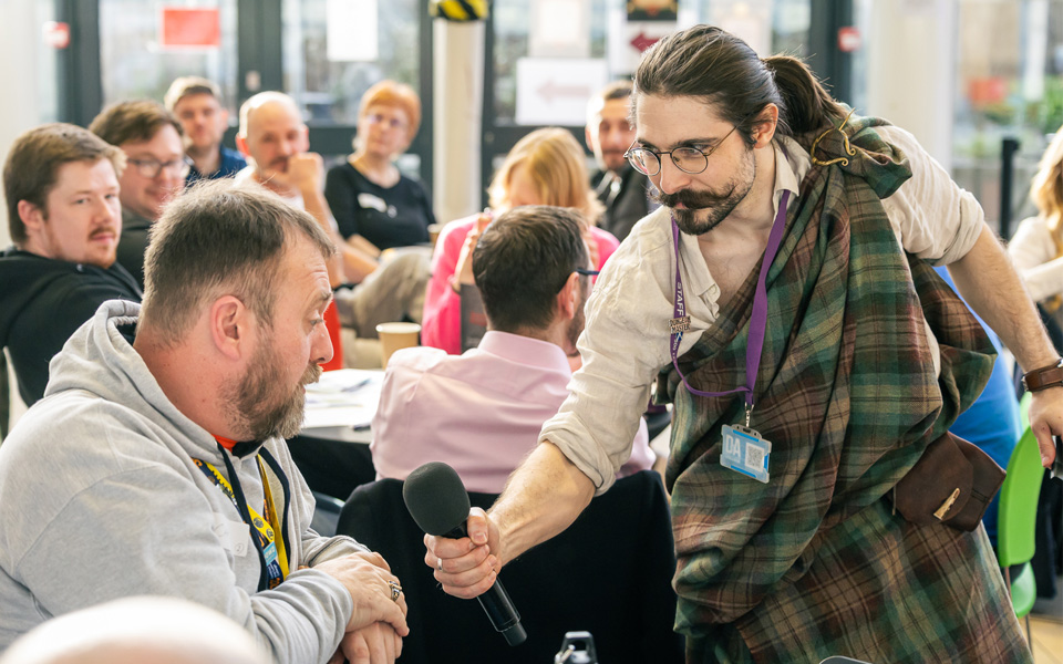 Member of staff speaking to audience member