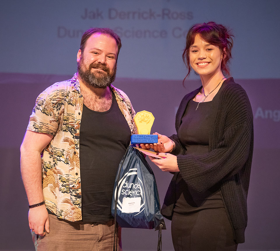 prize winner receiving their prize on stage