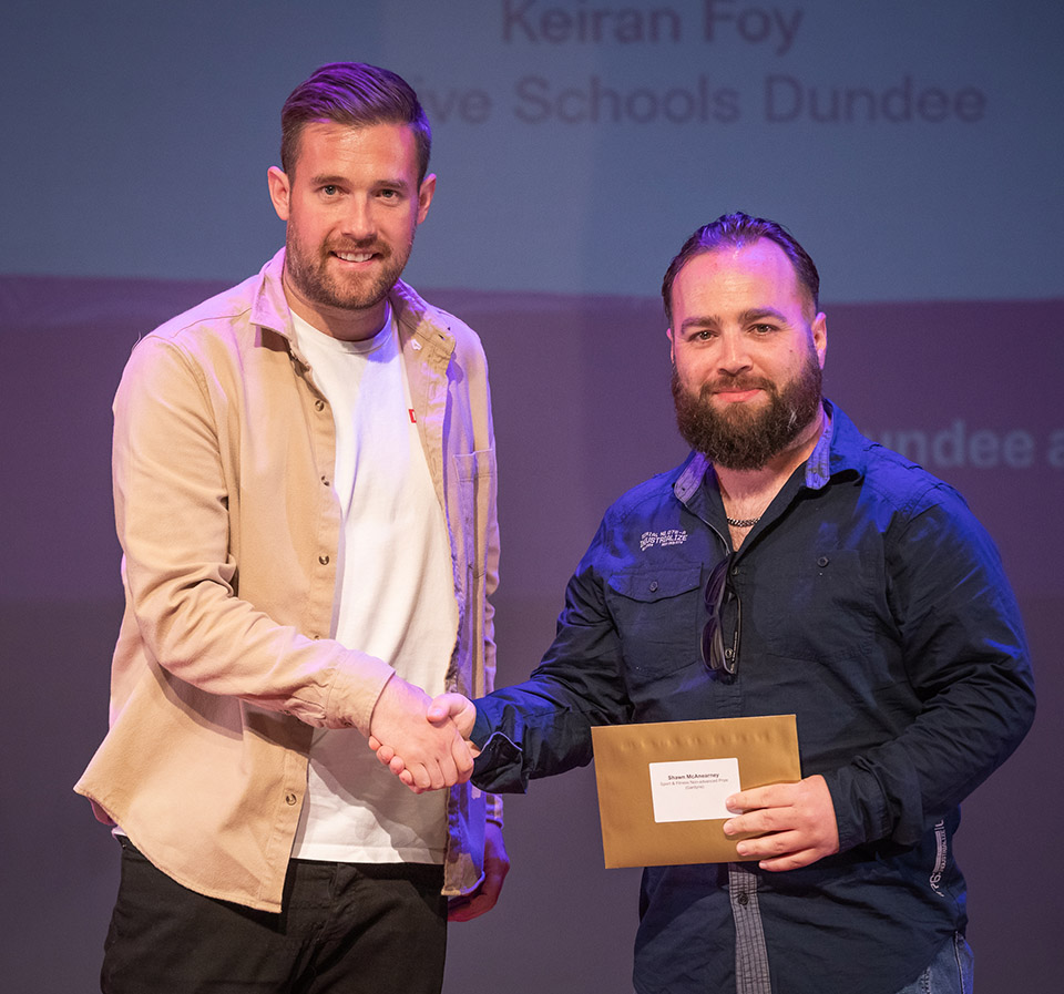 prize winner receiving their prize on stage