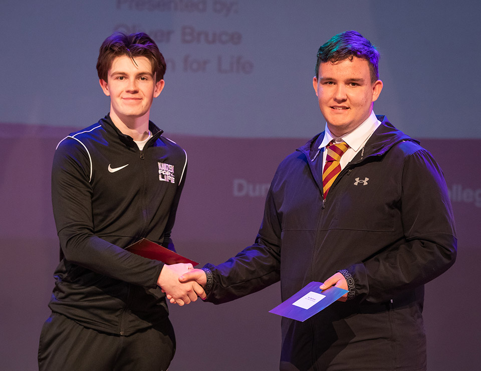 prize winner receiving their prize on stage