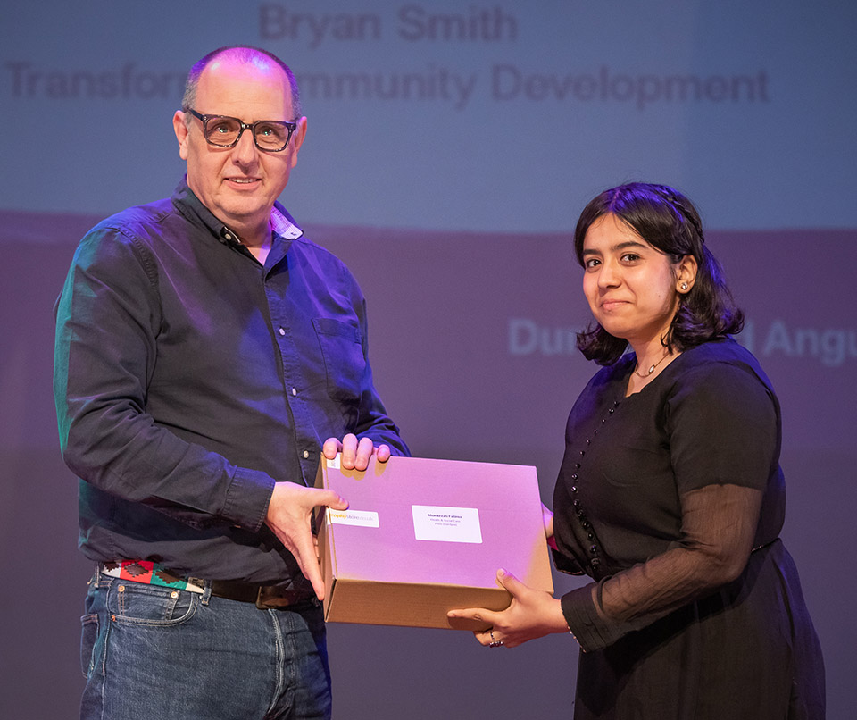 prize winner receiving their prize on stage