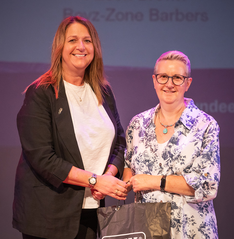 prize winner receiving their prize on stage