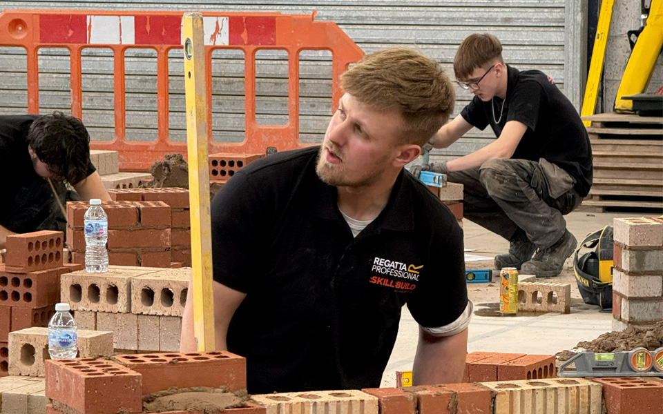 Bricklaying student measuring
